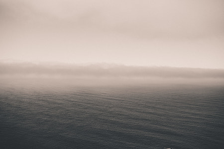 body of water under cloudy sky thumbnail