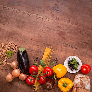 top view of a bunch of assorted vegetables on brown wooden surface thumbnail