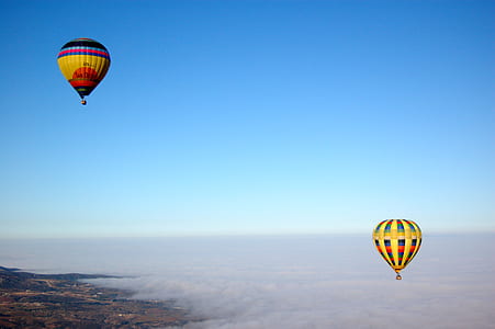 time lapse photography of two hot air balloons in flight thumbnail
