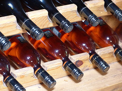 brown glass bottles in wooden rack thumbnail