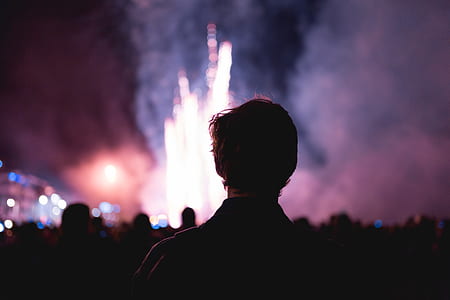man standing watching fireworks during nighttime thumbnail