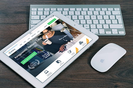 Apple Magic Mouse Beside White Ipad thumbnail