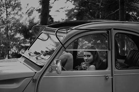 Grayscale Photo Of Woman Inside Classic Car thumbnail