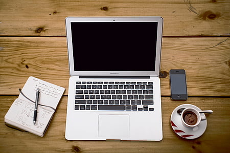 turned-off silver MacBook besides white ceramic teacup thumbnail