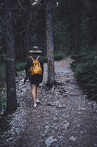 woman carrying backpack walking at the middle of forest thumbnail