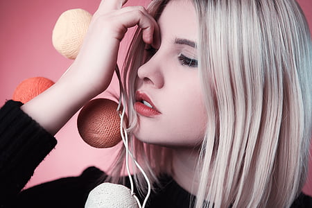 woman wearing black shirt holding yarn balls poster thumbnail