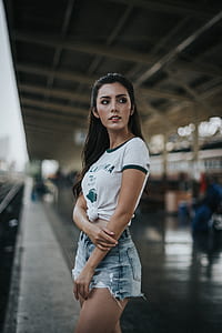 woman in gray crew-neck T-shirt and distressed blue denim shorts thumbnail