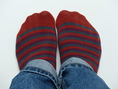 person showing pair of red-and-blue striped socks thumbnail