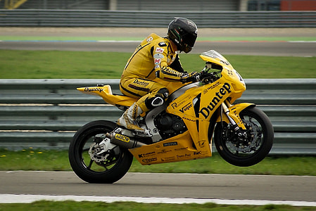 man wearing black full-face helmet riding yellow naked motorcycle thumbnail