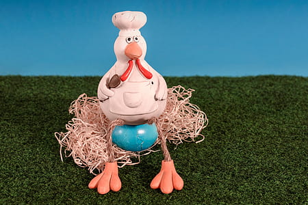 white chicken figure on green grass thumbnail