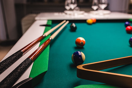 Billiard balls on green table with billiard cue thumbnail