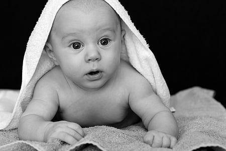 grayscale photo of a baby with white textile on top thumbnail