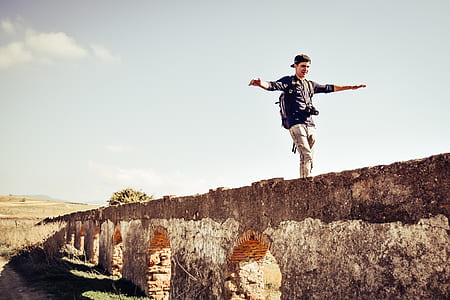 man walking on concrete wall thumbnail