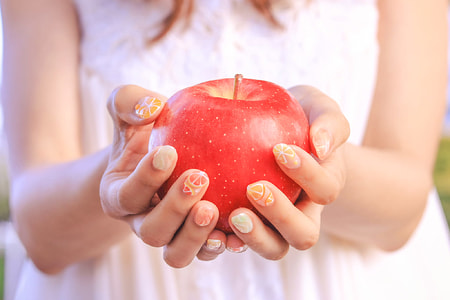 woman holding red apple fruit thumbnail