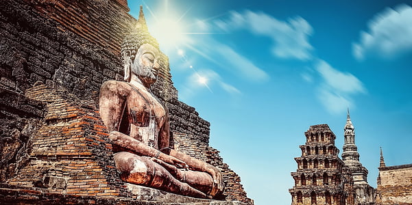 Gautama concrete statue near pyramid during daytime thumbnail