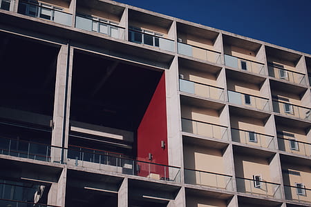 low angle photo of white and red painted building thumbnail