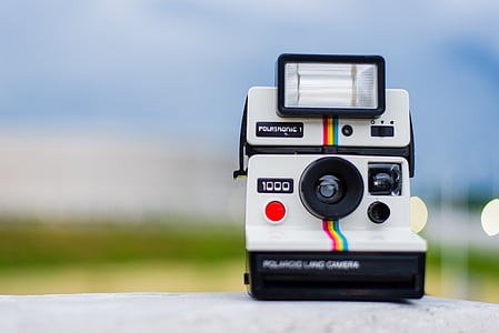 selective focus photo of white and black Polaroid land camera close up photo thumbnail