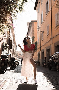 woman posing outside the beige house during daytime thumbnail