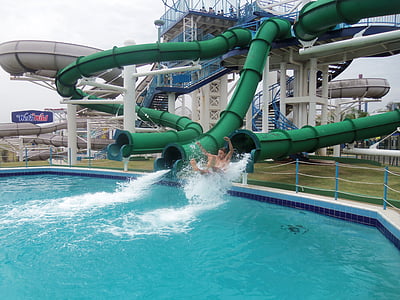 man sliding on pool during daytime thumbnail