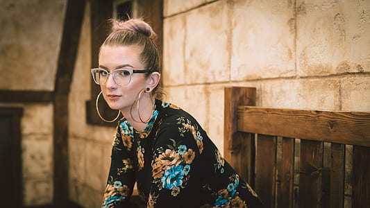 woman sitting on brown wooden bench chair thumbnail