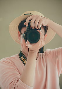 Man Holding Nikon Dslr Camera thumbnail