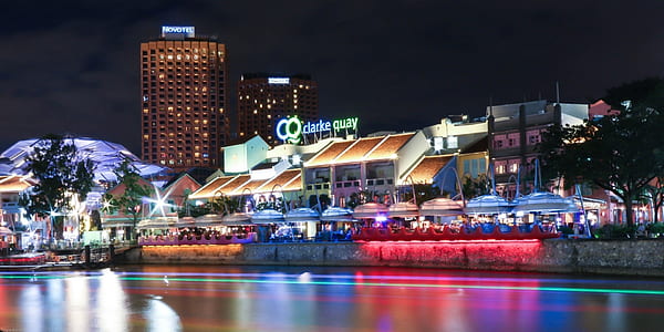 lighted building beside body of water at nighttime thumbnail