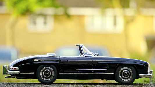 focus photography of black convertible coupe die-cast scale model thumbnail