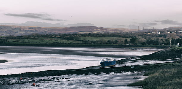 fishing boat on seashore thumbnail