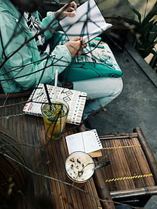 person holding paper white sitting on bench thumbnail