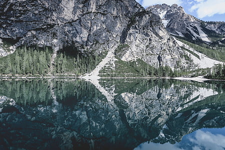low-angle photography of reflection of mountain alps on body of water thumbnail