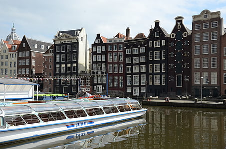 boat on body of water near concrete building thumbnail