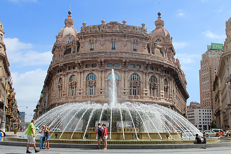 people walking near the water fountain and concrete palace thumbnail