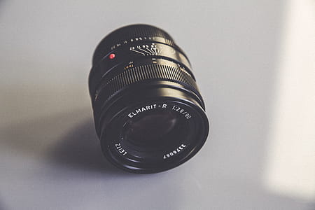 black DSLR camera lens on white surface thumbnail