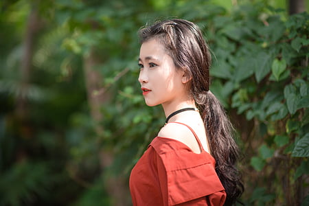 close up photo of long-haired woman in red cold-shoulder top thumbnail