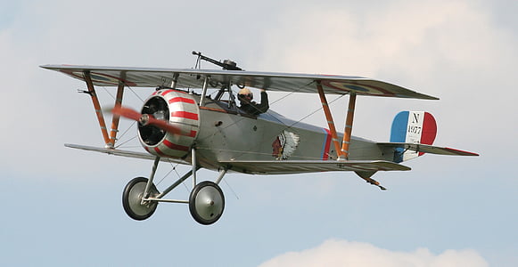 photography of gray and red biplane during daytime thumbnail