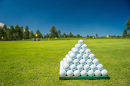 white golf balls on green fieled thumbnail