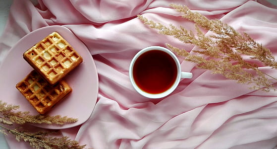 white ceramic mug beside biscuits thumbnail