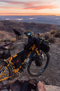 black and yellow mountain bicycle on brown rock thumbnail