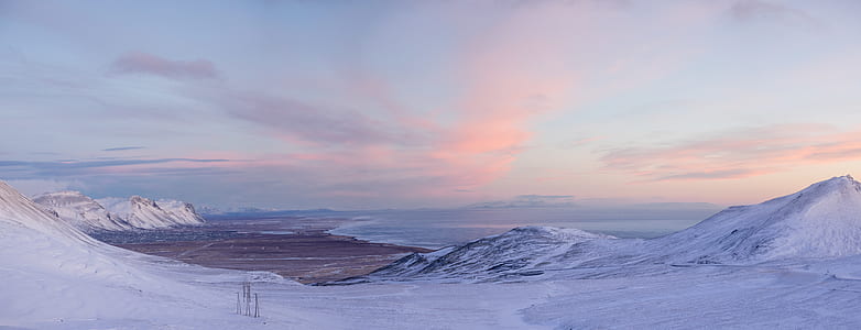 landscape photography of snow coated ground near body of water thumbnail