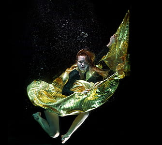 woman in yellow and black dress underwater thumbnail