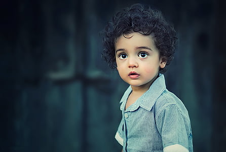 selective focus photo of a boy wearing blue button-up shirt thumbnail