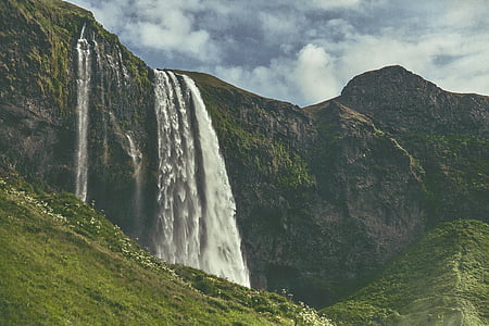 waterfalls on the mountain during daytime thumbnail