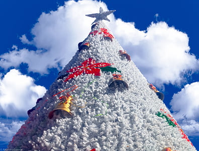 white Christmas tree with ornaments under white clouds thumbnail