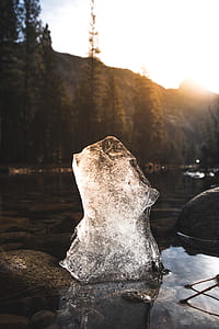 selective focus photography of ice block on body of water thumbnail