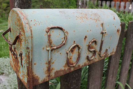 gray mailbox on brown plank fence thumbnail