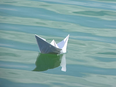white boat paper on body of water thumbnail