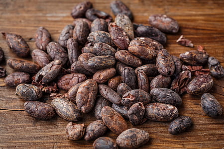 selective focus photography of brown beans on brown wooden surface thumbnail