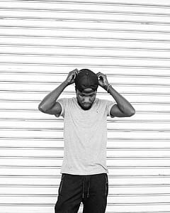 Monochrome Photo of Man Touching His Cap thumbnail