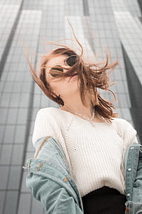 woman in white sweater posing for a photo thumbnail