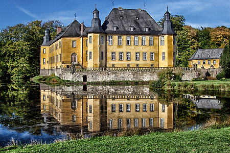 yellow and gray concrete building near body of water thumbnail